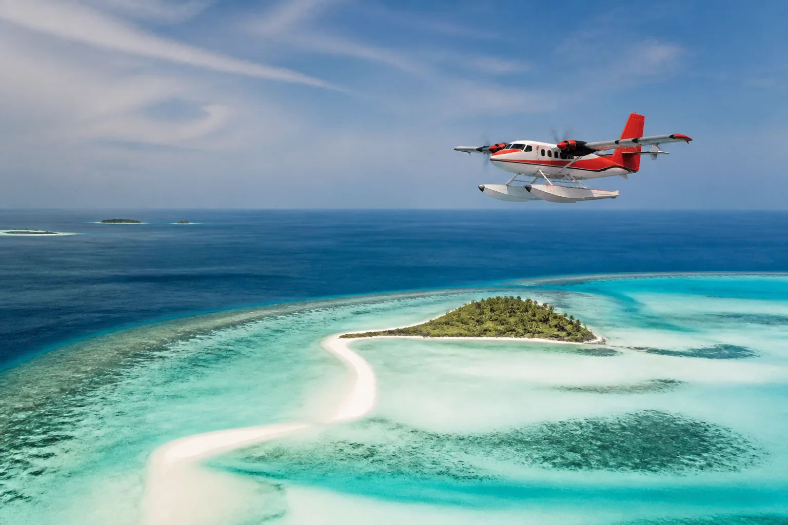 Trans Maldivian Airways seaplane above a Maldivian lagoon