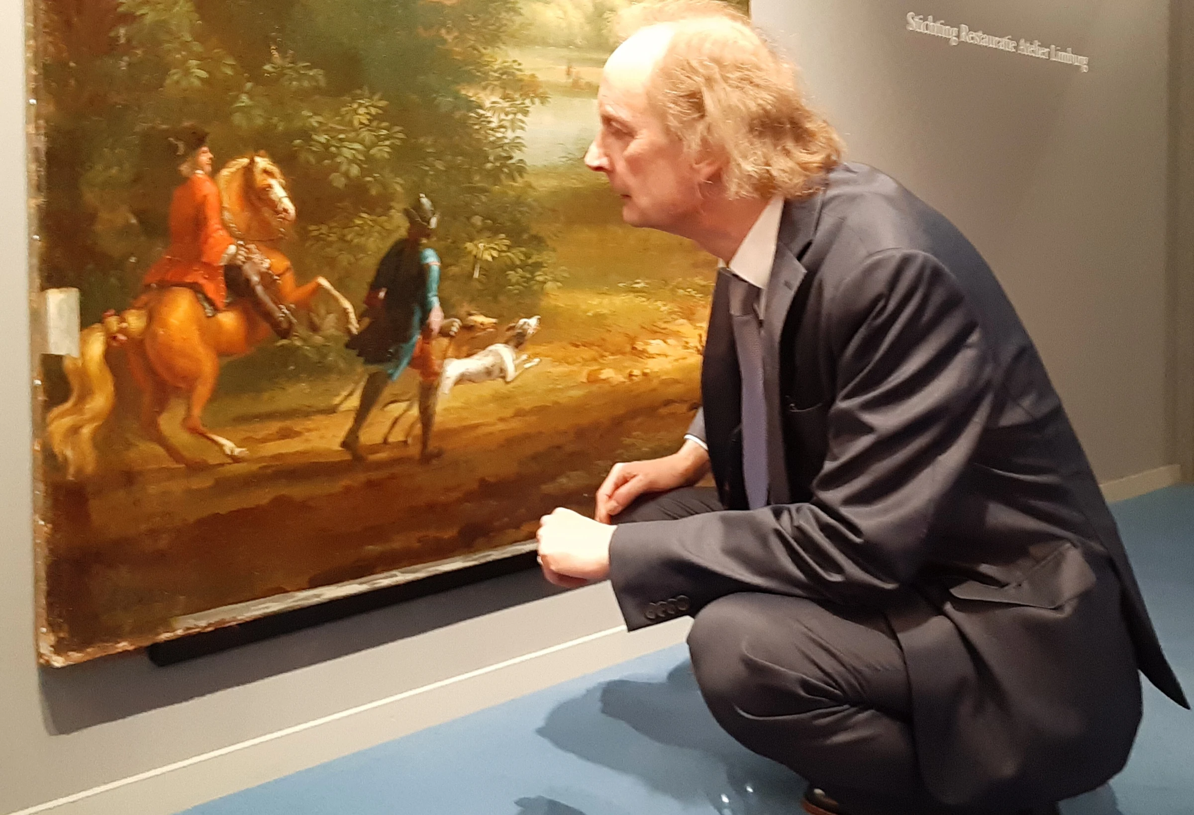 Conservation specialist René Hoppenbrouwers examining a painting at TEFAF 2019