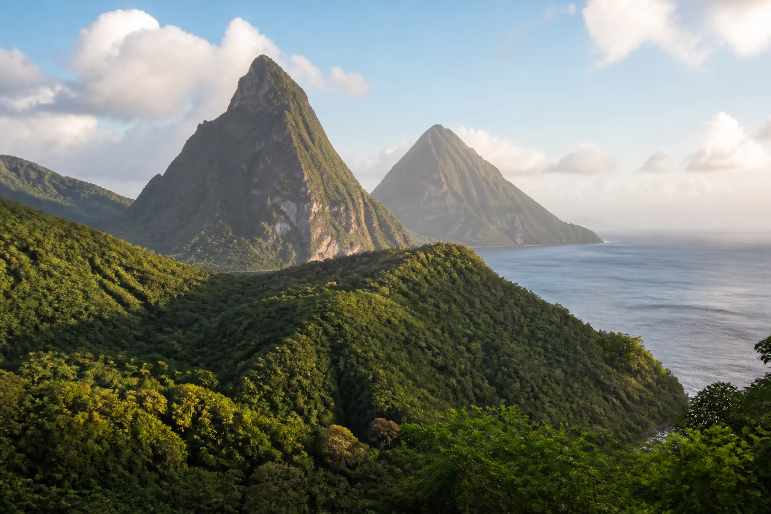 Petit Piton and Gros Piton above the green Soufrière landscape in Saint Lucia