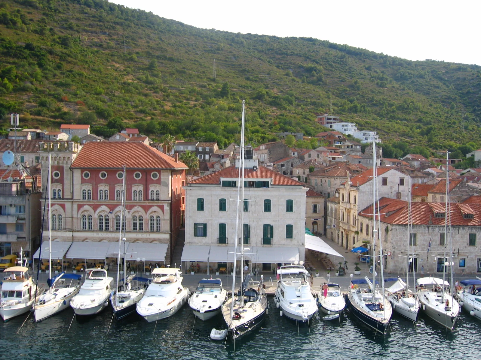 Sailing and motor yachts before the historic waterfront in Vis harbour