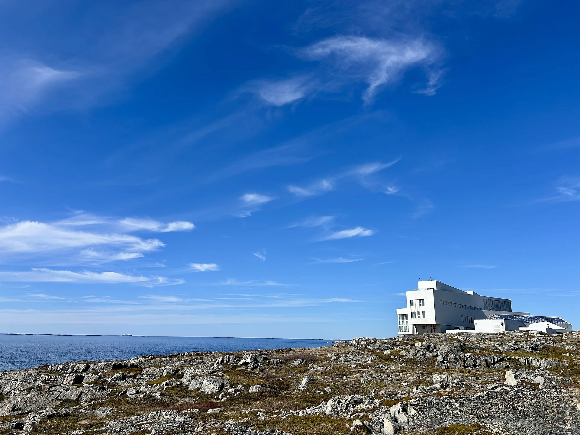 Fogo Island Inn at small scale within its rocky Atlantic landscape