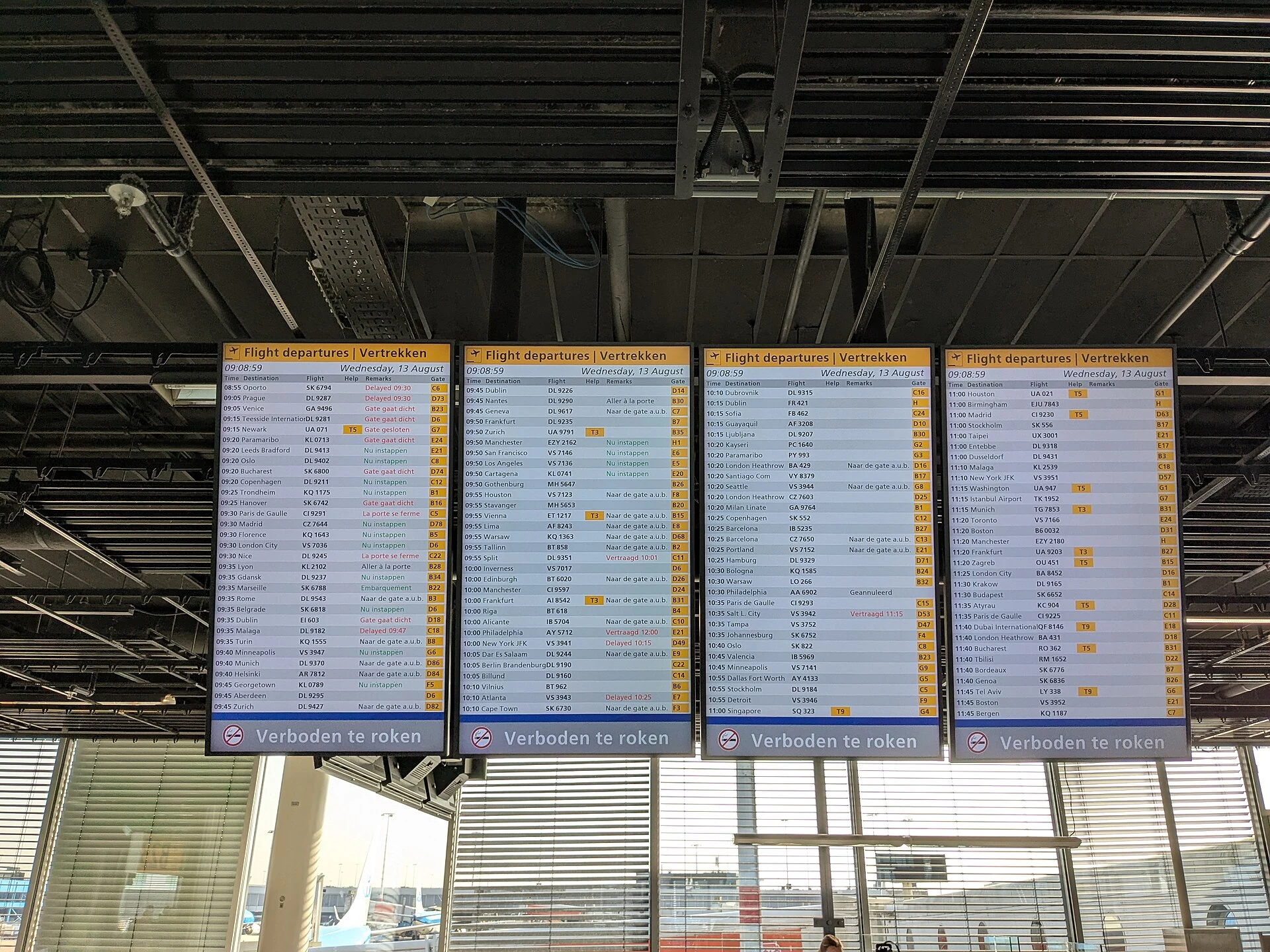 Departure boards at Amsterdam Schiphol Airport on the morning of 13 August 2025