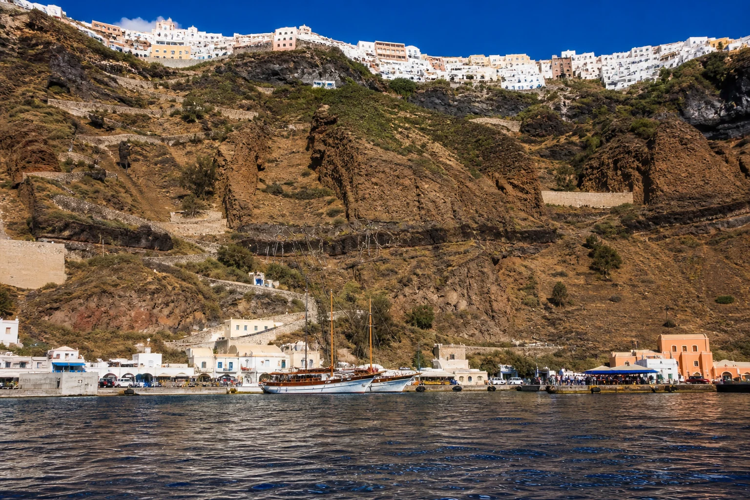 Athinios port beneath Santorini’s steep crater rim