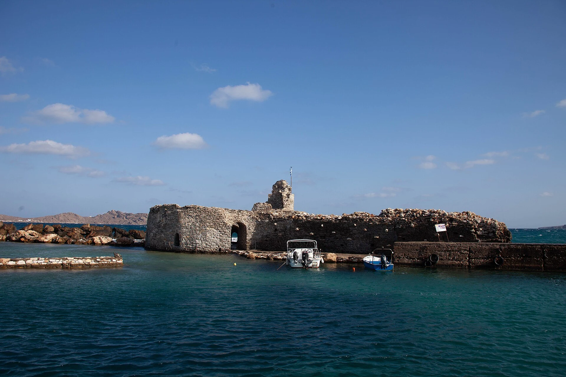 Boats beside the Venetian castle in Naoussa harbour on Paros