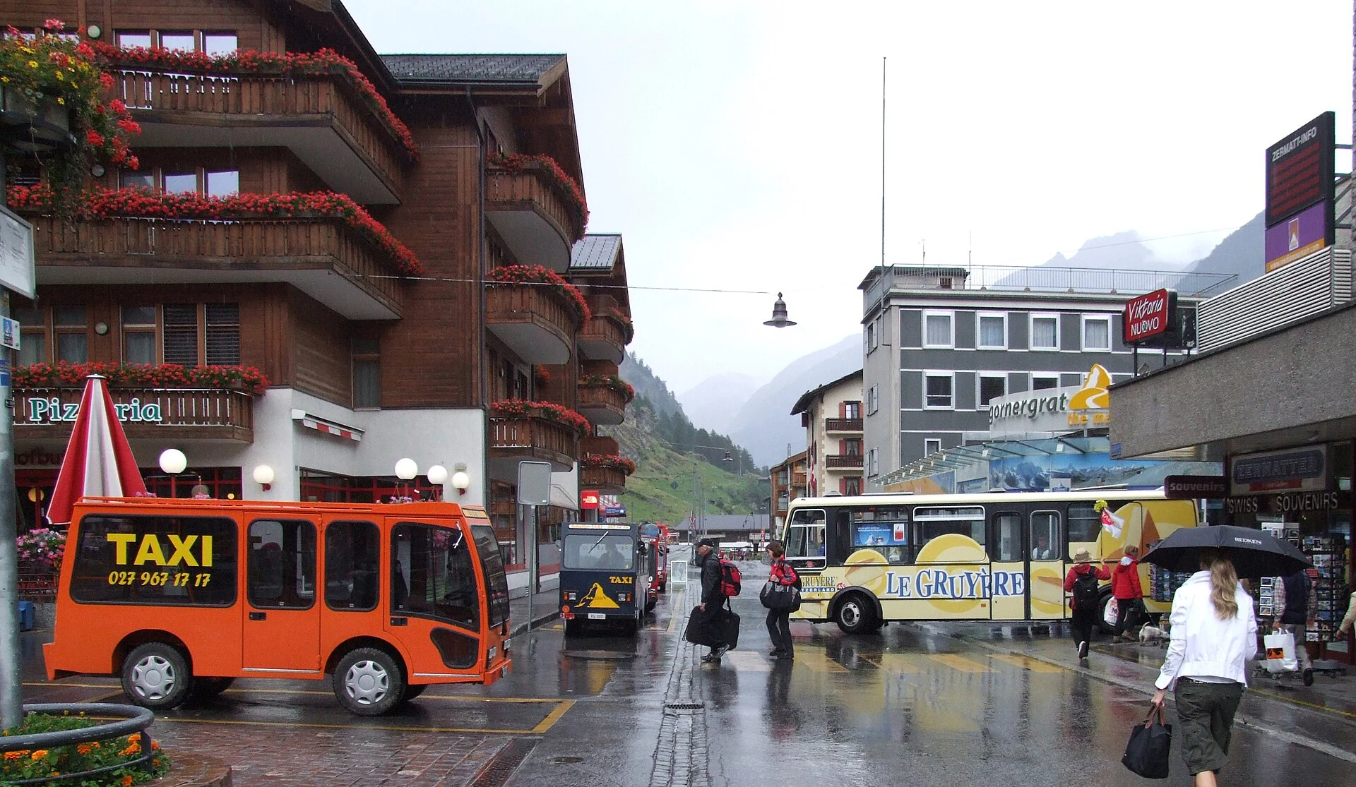 Electric taxis and an electric bus in rainy, car-free Zermatt