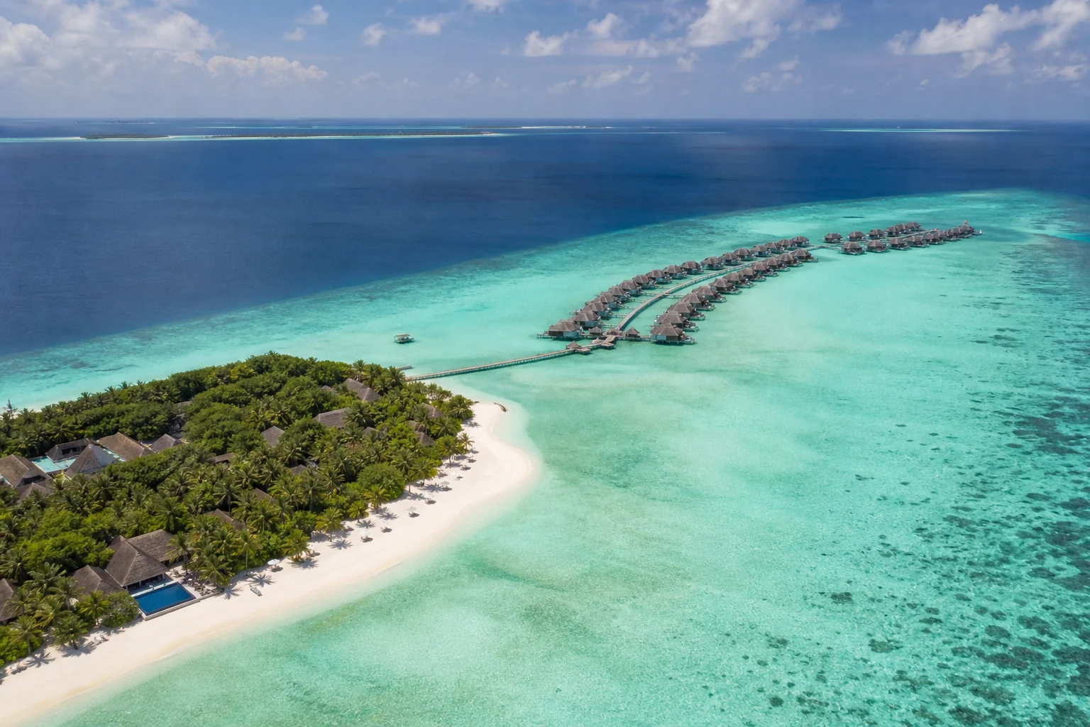 Aerial view of Anantara Kihavah Maldives Villas with beach and overwater villas