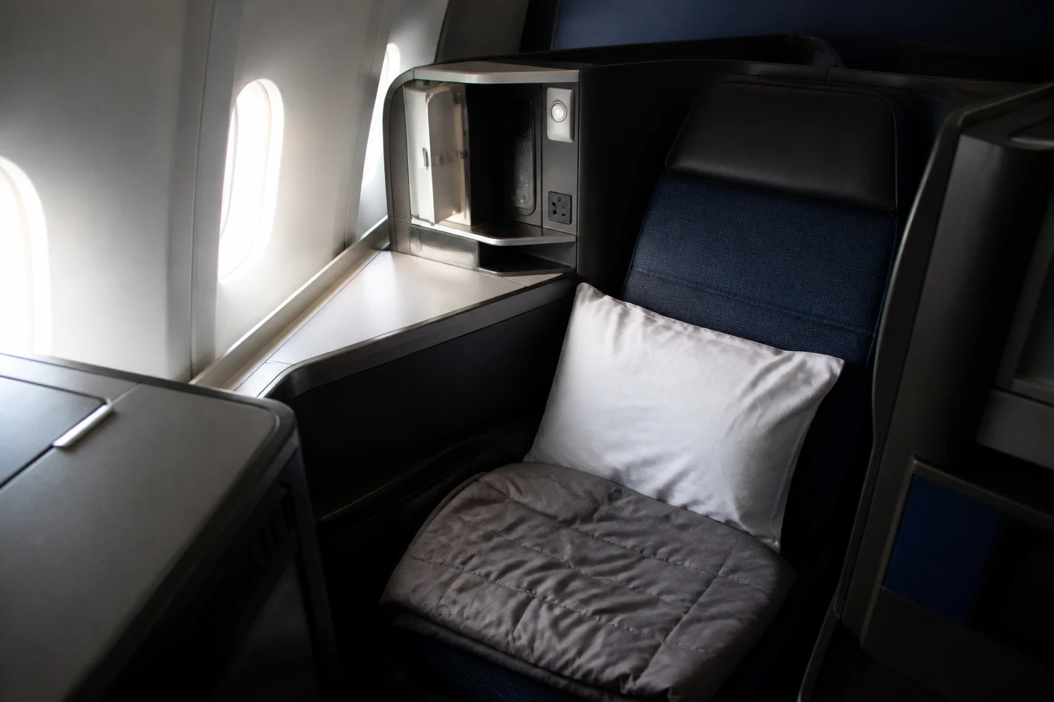 Historical United business-class seat with pillow and blanket