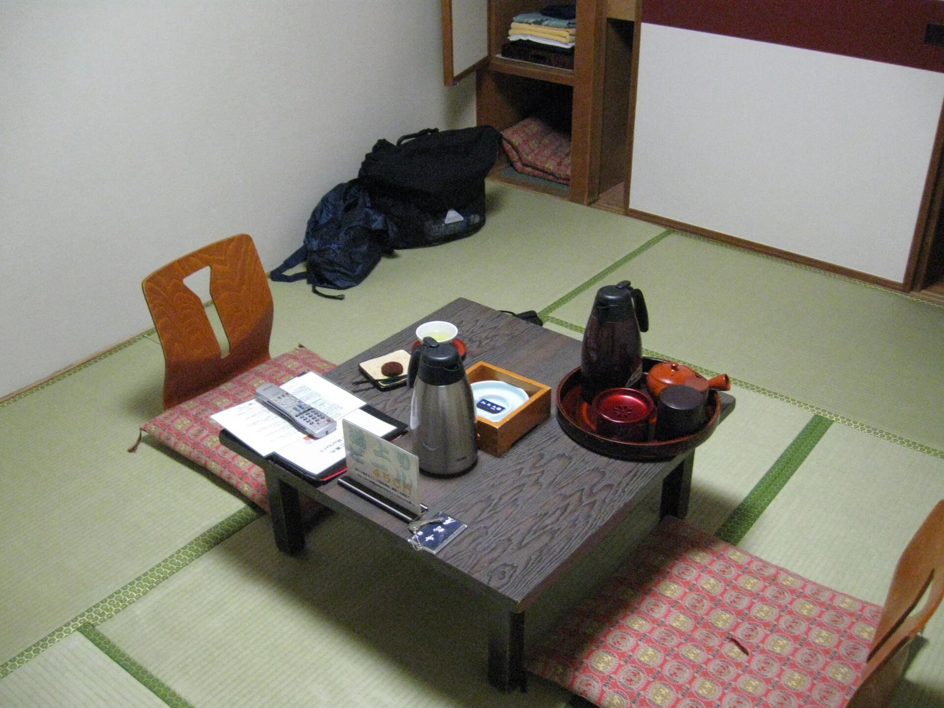 Tatami ryokan room with a low table and floor chairs