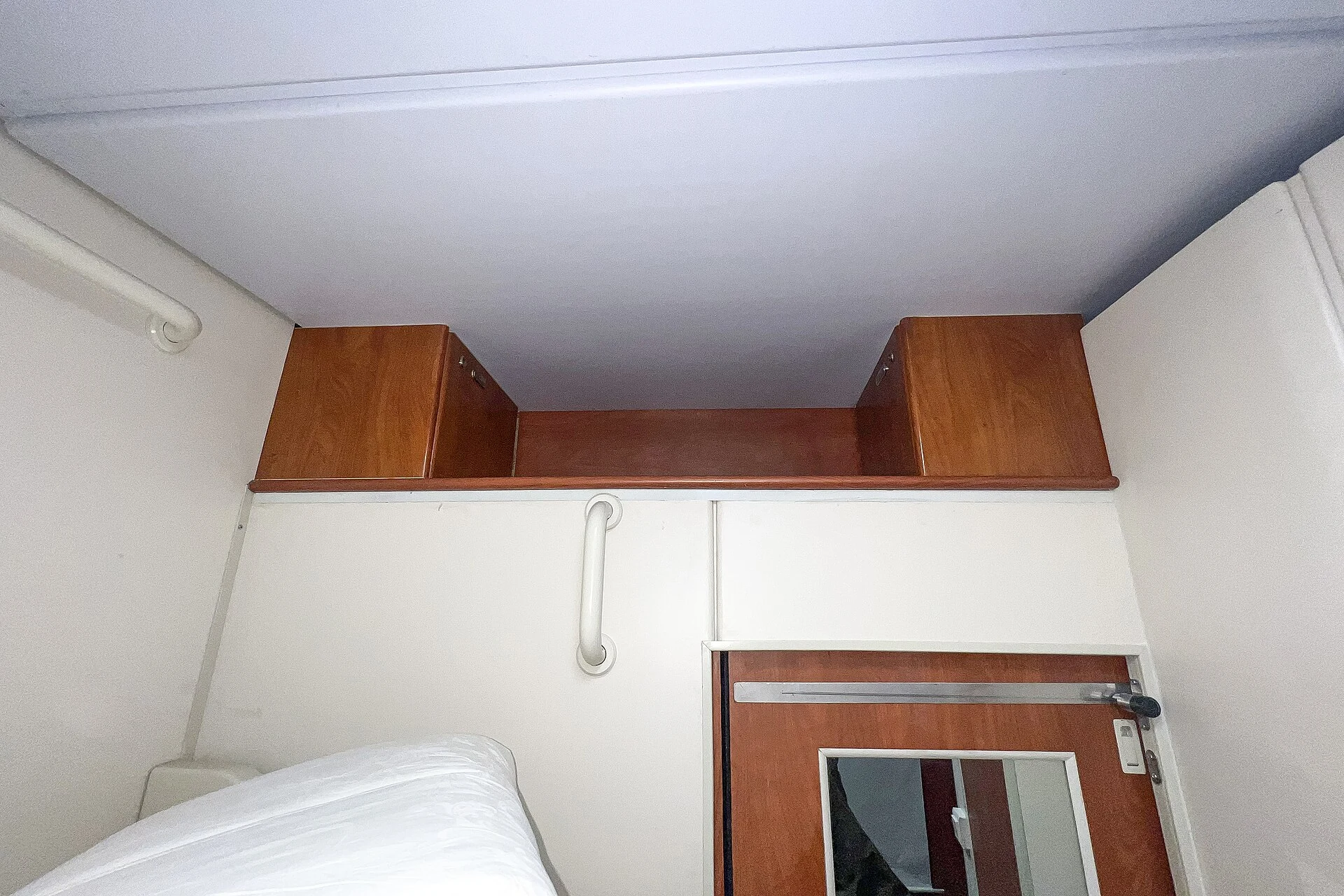 Open luggage shelf above the door of a real Chinese deluxe sleeper compartment