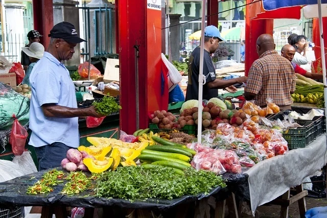 Produce stalls and vendors inside the real Victoria Market on Mahé