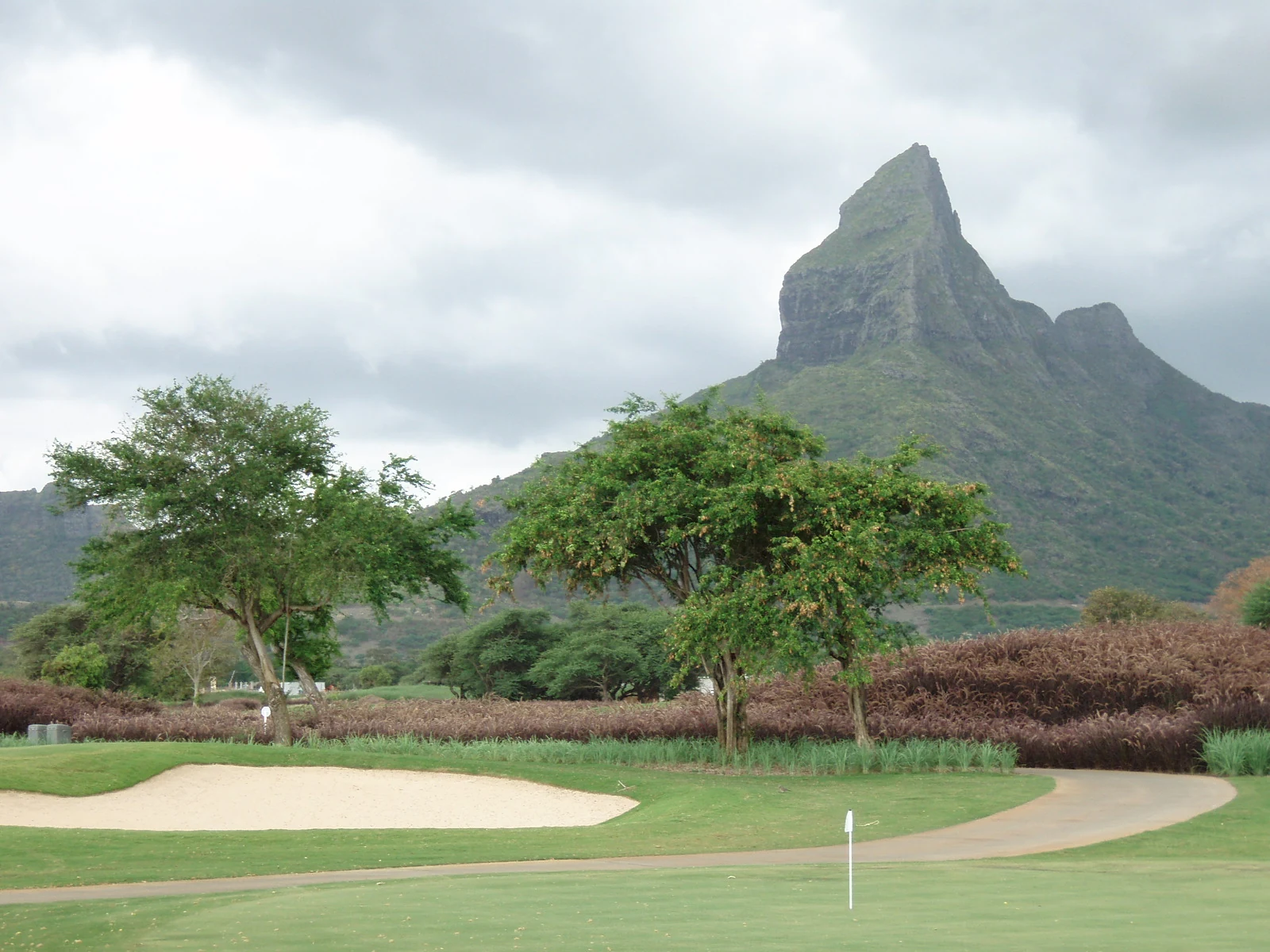 Real Tamarina Golf Course in Mauritius with fairway, bunker and mountain backdrop