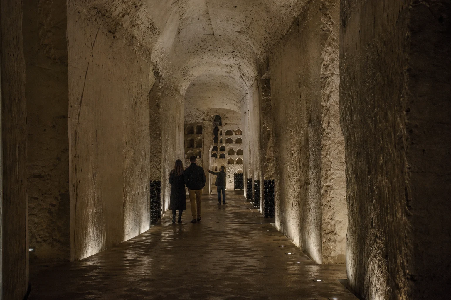 Small visitor group in a historic Champagne chalk cellar