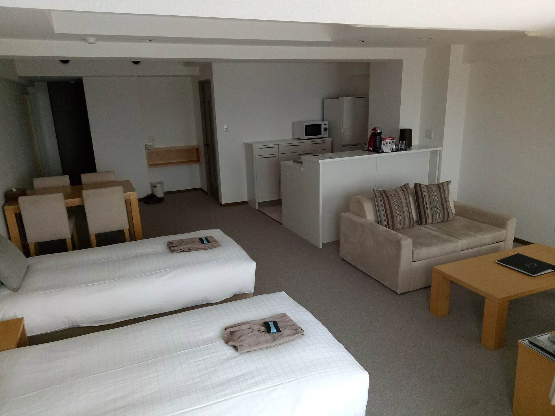 Quiet room at One Niseko Resort Towers with beds and a small kitchen