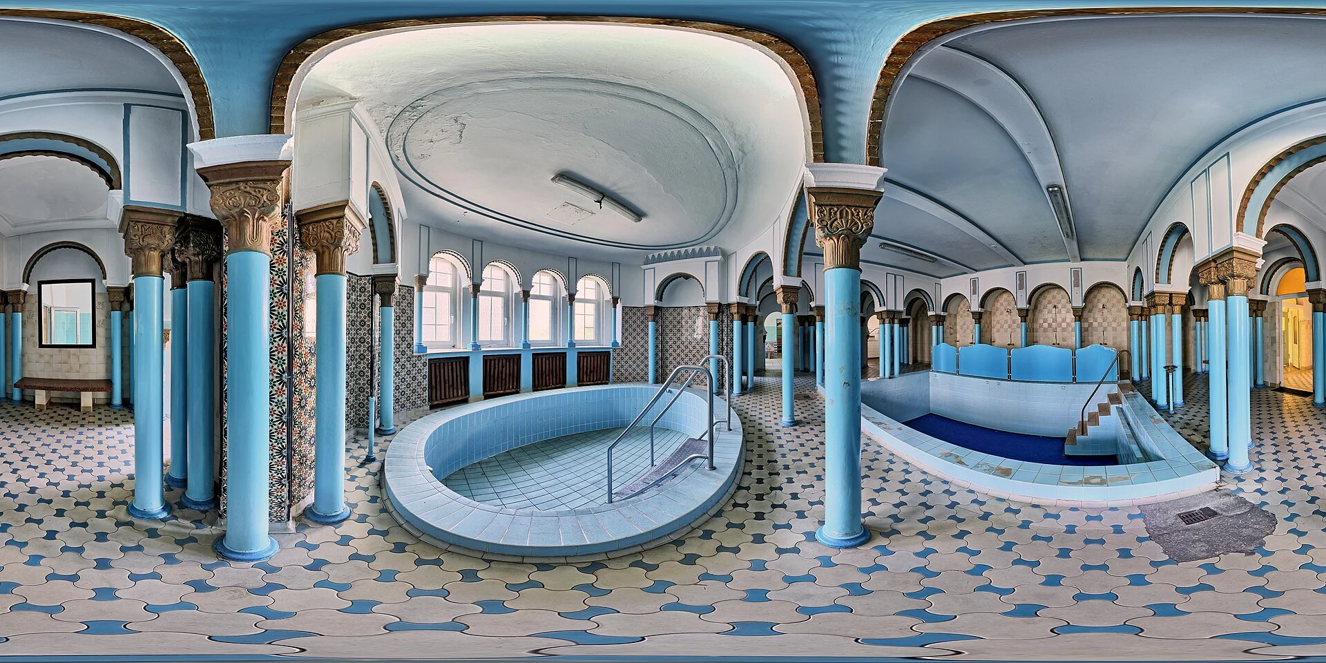 Empty plunge pools at Leipzig Stadtbad with handrails and steps