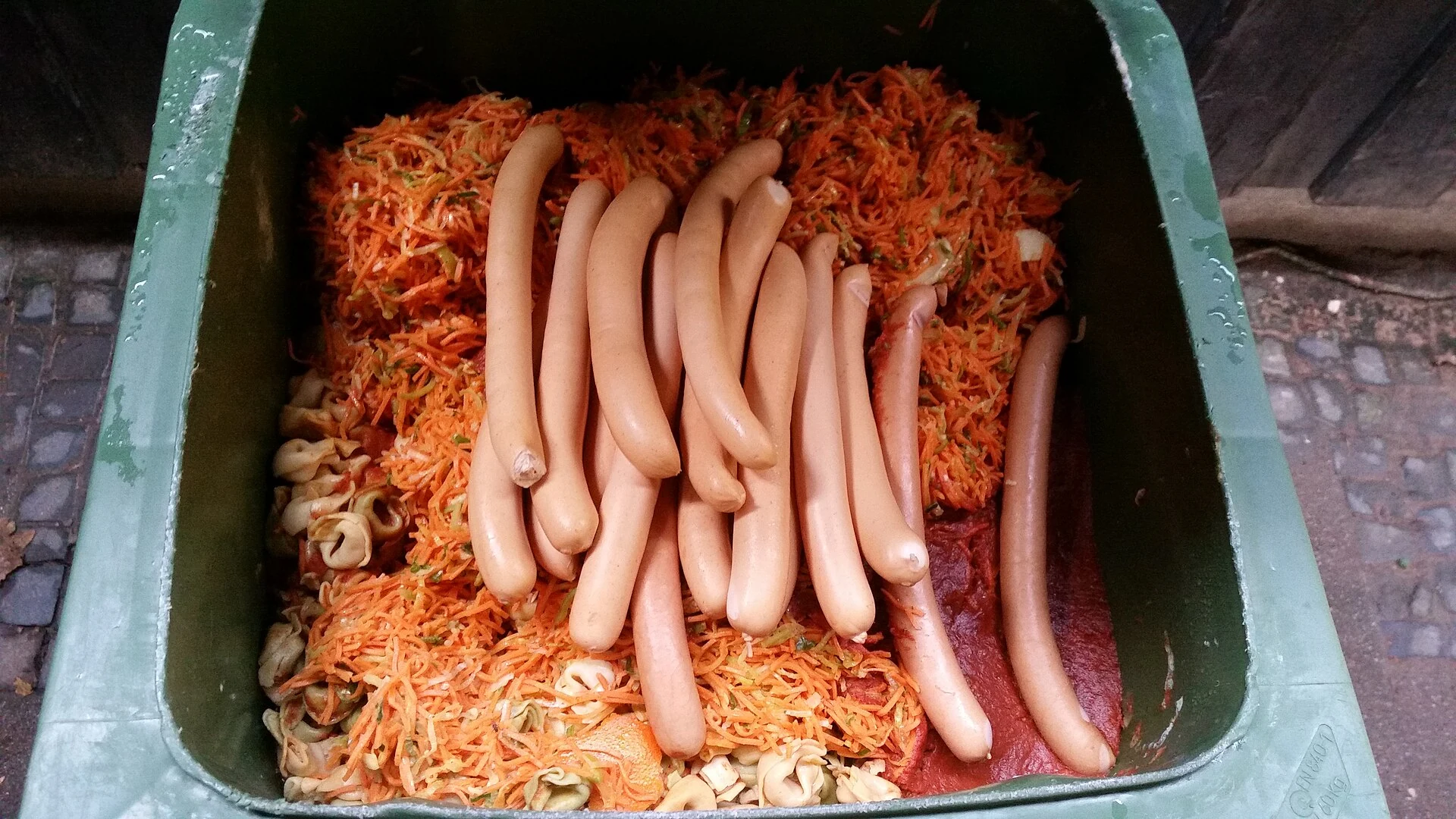 Real prepared food discarded in a waste container